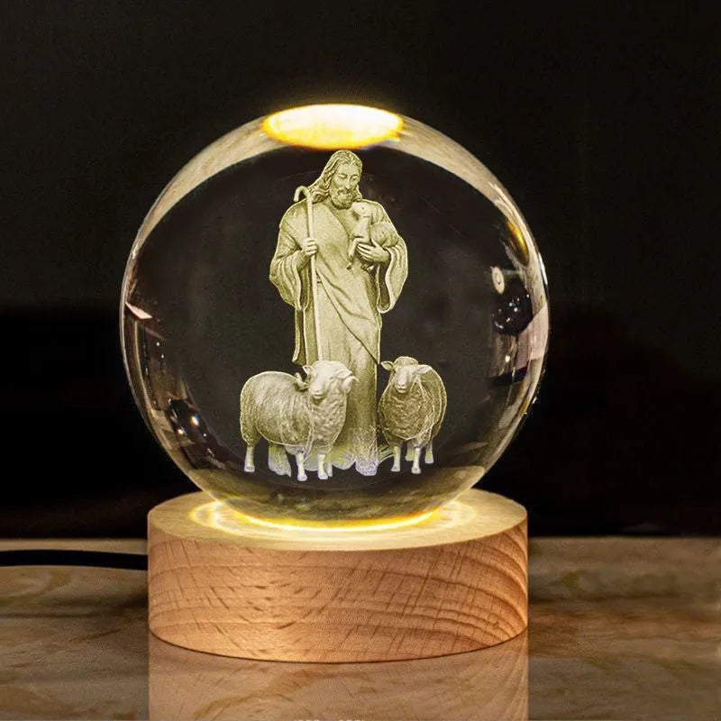 White crystal ball ornament on wood base with warm light and religious symbols
