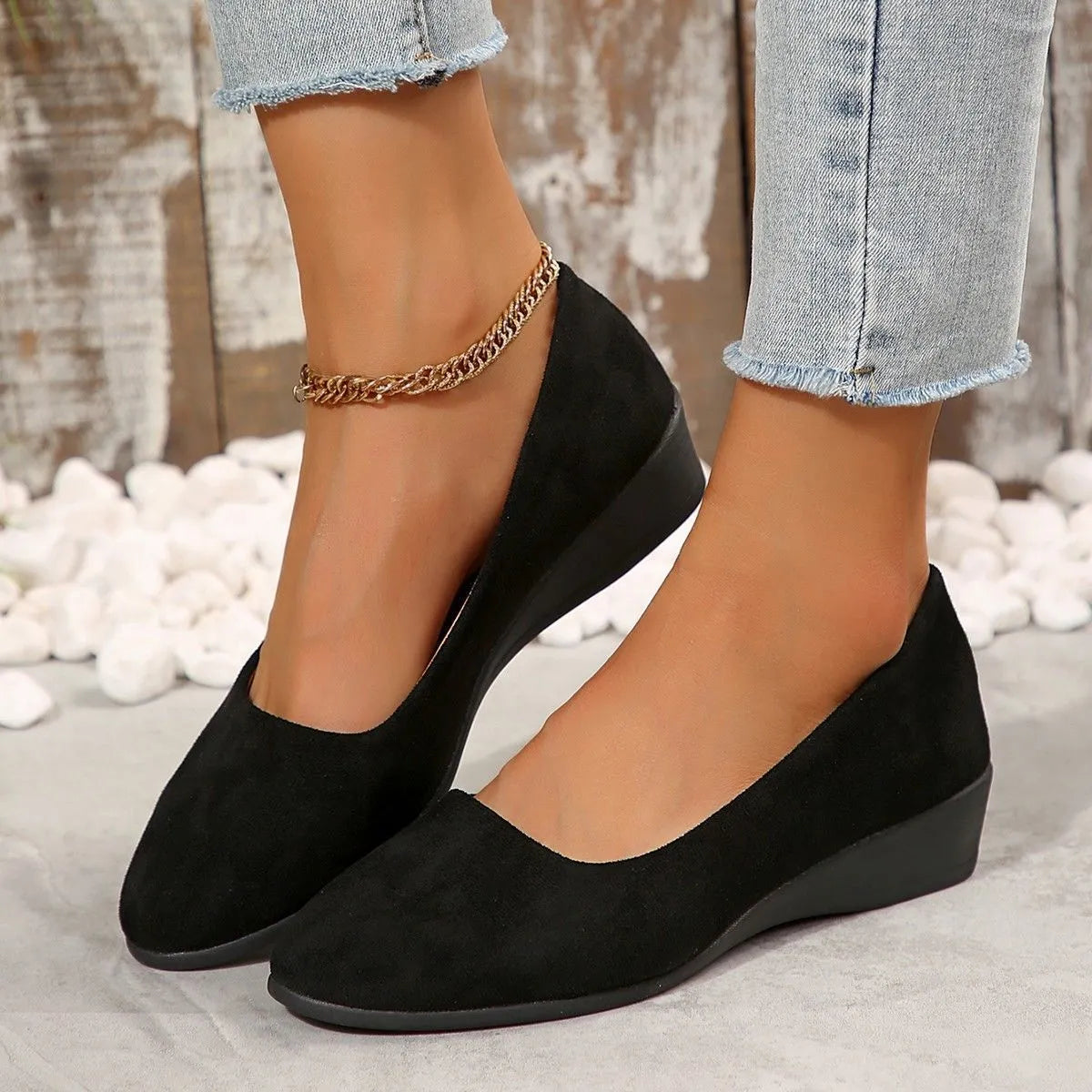 Women's pointed toe wedge pumps in suede with a low heel and shallow mouth opening.
