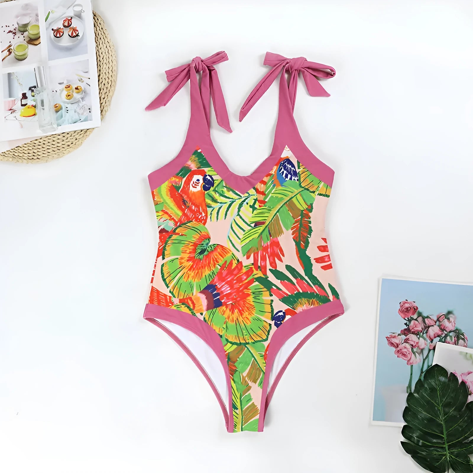 Pink floral print women's one-piece swimsuit with V-neck and matching skirt on beach