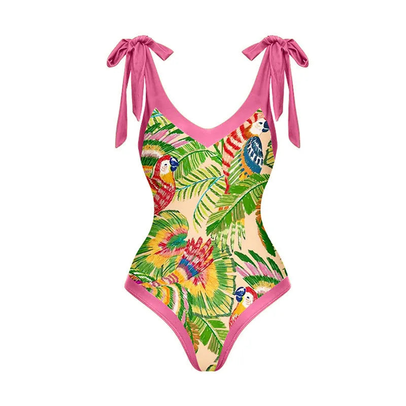 Pink floral print women's one-piece swimsuit with V-neck and matching skirt on beach