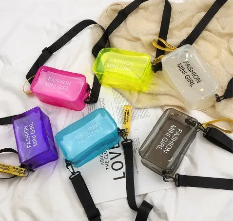 Transparent square women's shoulder bag in jelly material with a diagonal cross strap, showing internal mobile phone pocket.