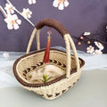 Coffee brown hand-woven straw basket with hemp rope detailing, 19cm long by 12cm wide