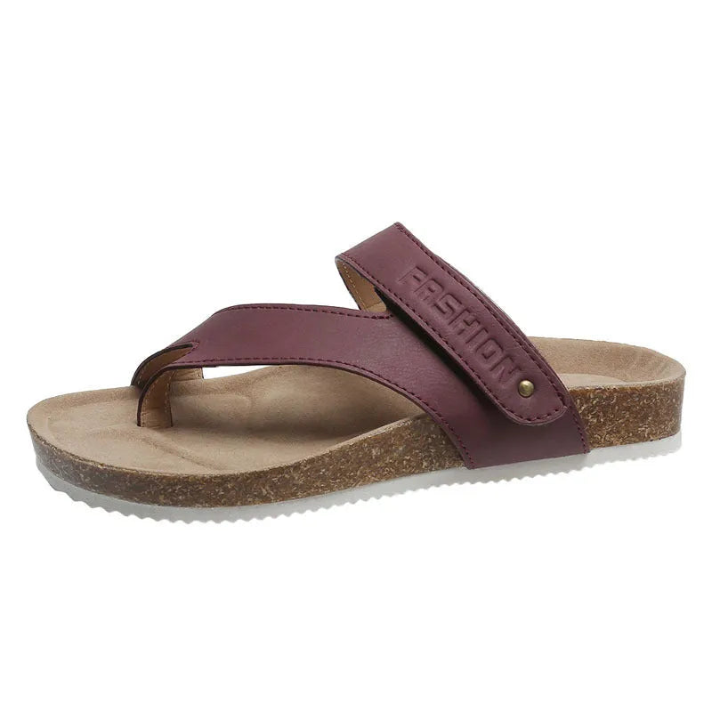 A pair of thick-soled flat toe ring flip-flops in a solid colour on a white background.