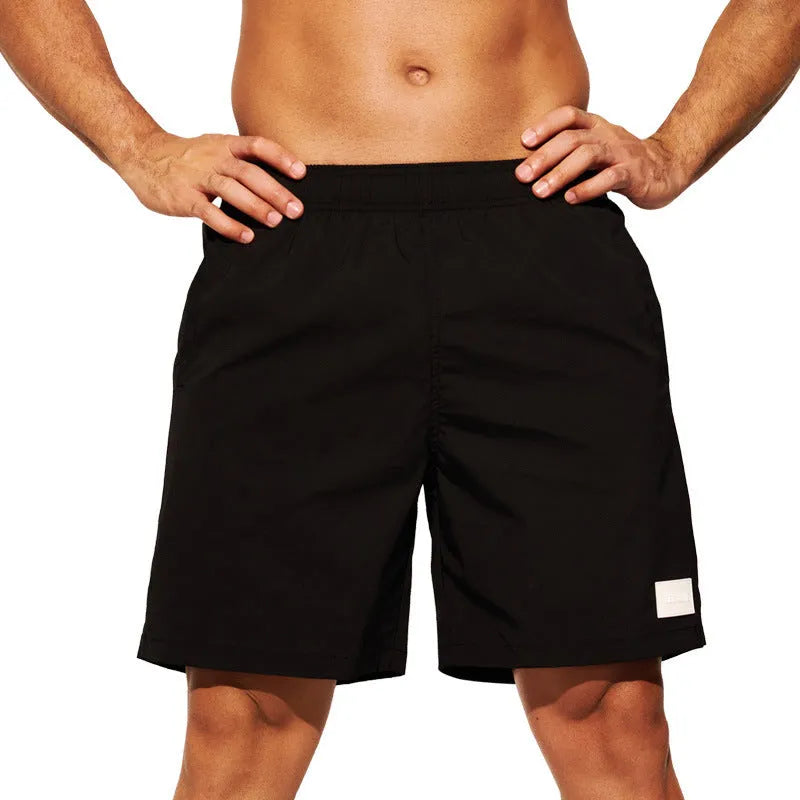 Men's solid colour quick-drying nylon sports shorts on a white background.