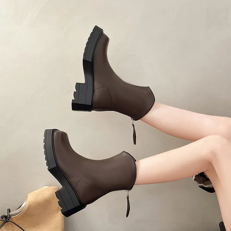 Black platform Martin boots for women with a square toe, mid calf length, and a high heel.