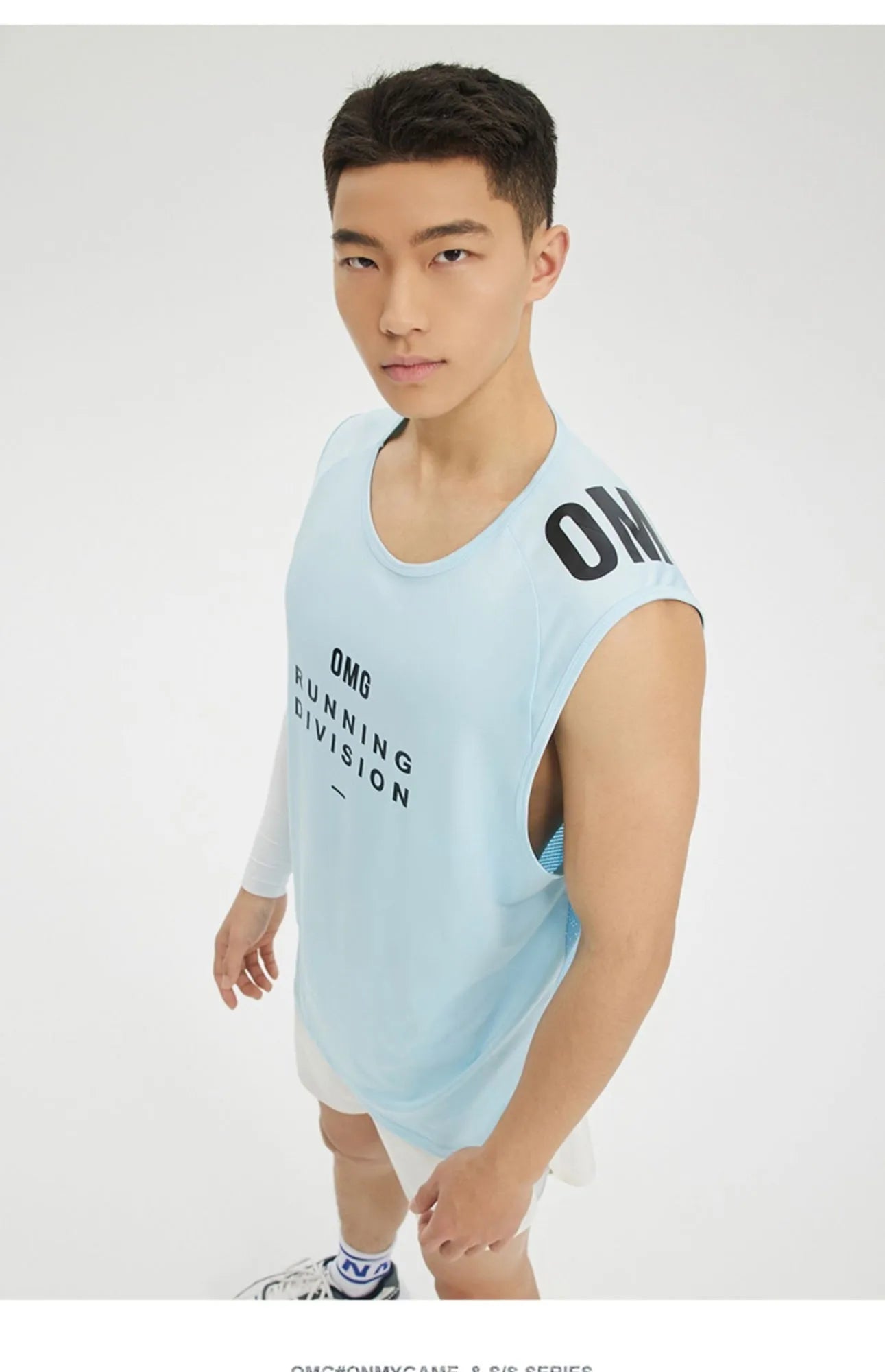 Man wearing a lightweight grey mesh sports vest, showing loose fit and breathable fabric for exercise.
