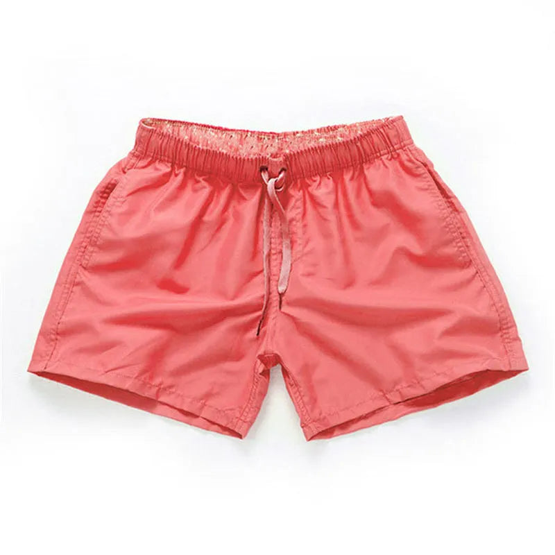Men's straight-leg beach shorts in polyester, shown in a colour from the range including fluorescent yellow, black, or navy.