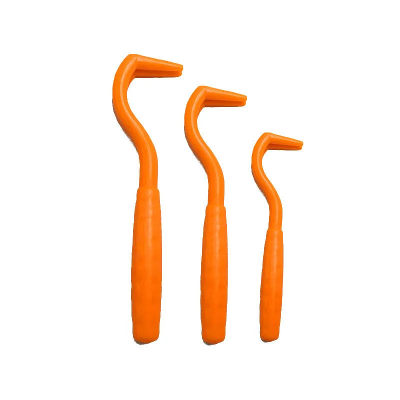 Three plastic tick removal hooks for dogs in various colours on white background