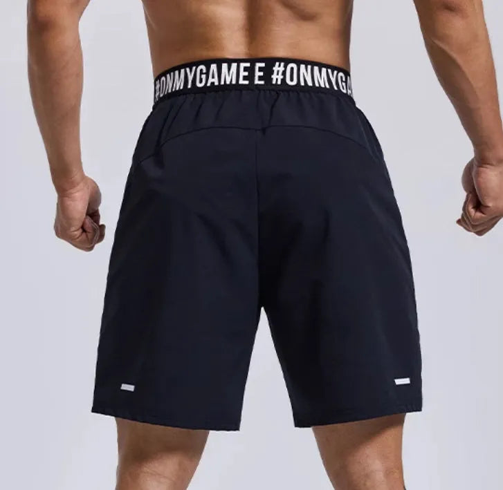 Men's loose-fit cropped sports shorts in black with elastic waist and letter details