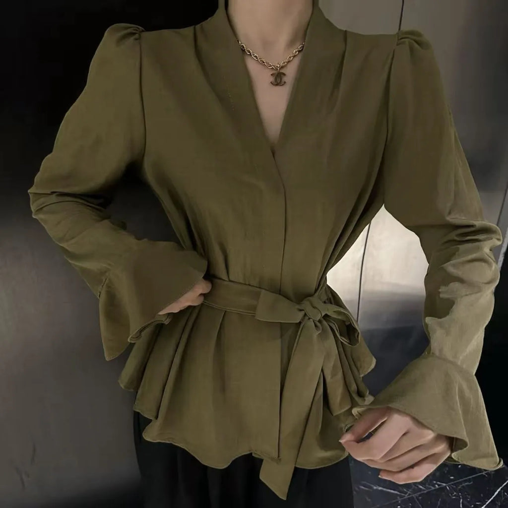 Women's black French-style shirt with irregular collar, long bell sleeves, and a front tie detail.