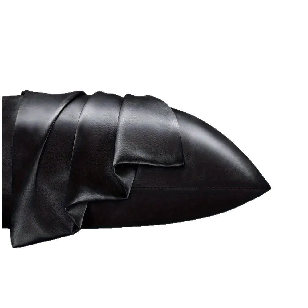 A pair of solid colour satin cloth pillowcases in a chosen shade and size on a bed.