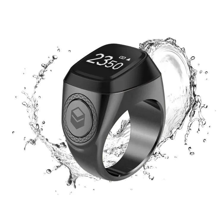 Silver smart ring with a small OLED screen displaying numbers, shown next to its charging case.