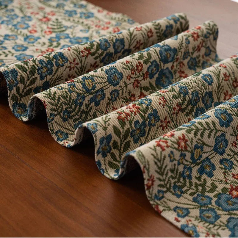 Dark blue Nordic jacquard table runner with bouquet pattern and tassel fringe on wooden table