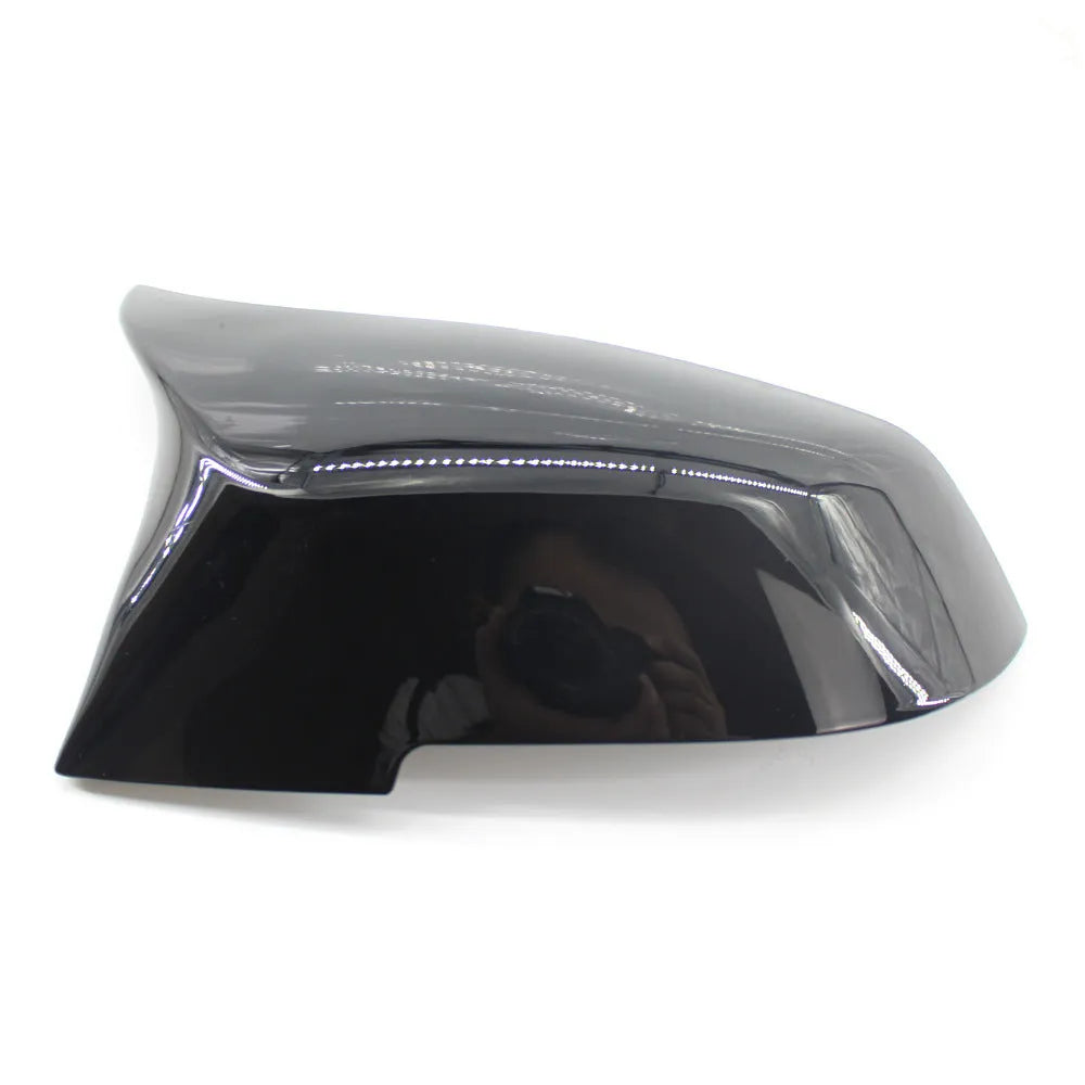 Pair of paint bright black BMW rear-view mirror replacement shells for 3 Series and 4 Series models.