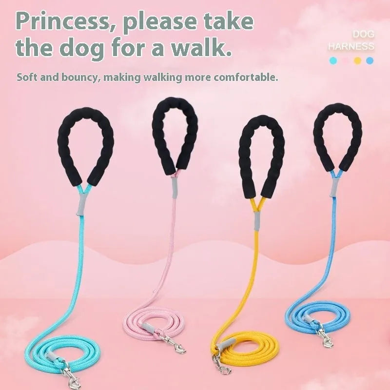 A pink dog vest harness connected to a matching hand-holding lead on a white background.