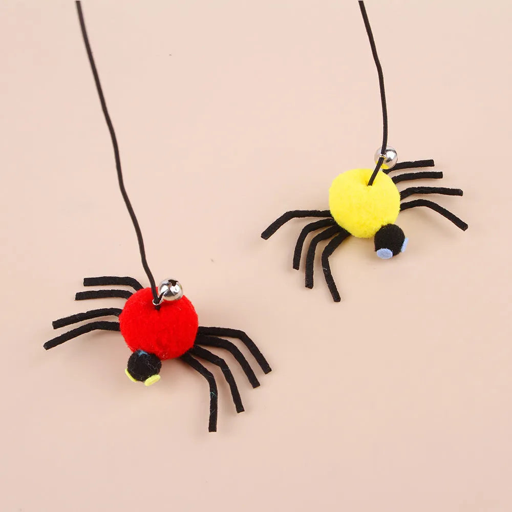 Red and yellow cat hanging door toy with elastic rope, feather, bell, and spider decoration.