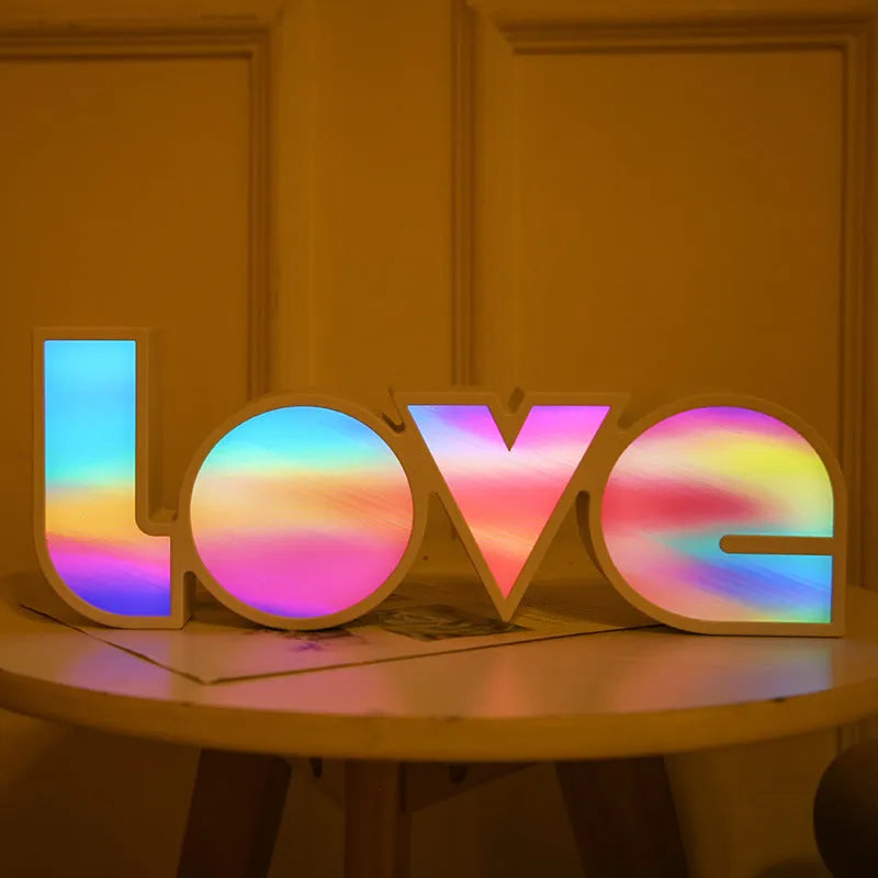 Colourful LED love light decorative lamp with plastic shell on a table