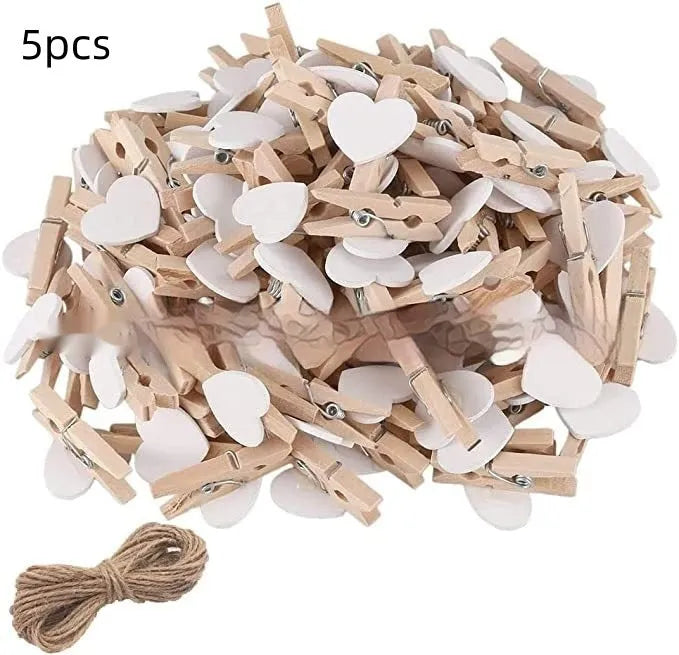 Five handmade solid wood heart-shaped clips in red, white, and pink on a wooden surface.