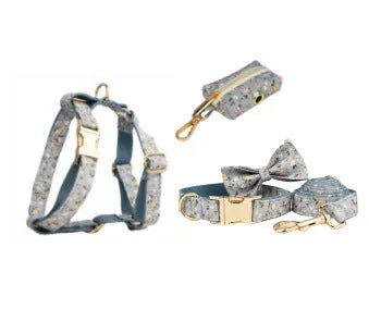 Blue floral pattern dog collar set with matching leash, bow, vest and waste bag dispenser accessories
