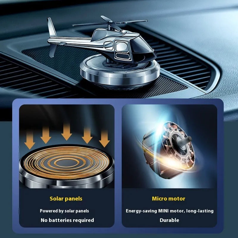 Silver metal solar helicopter car air freshener ornament rotating on dashboard