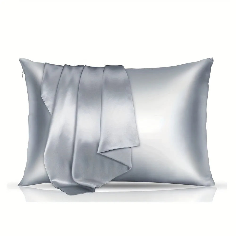 A pair of solid colour satin cloth pillowcases in a chosen shade and size on a bed.