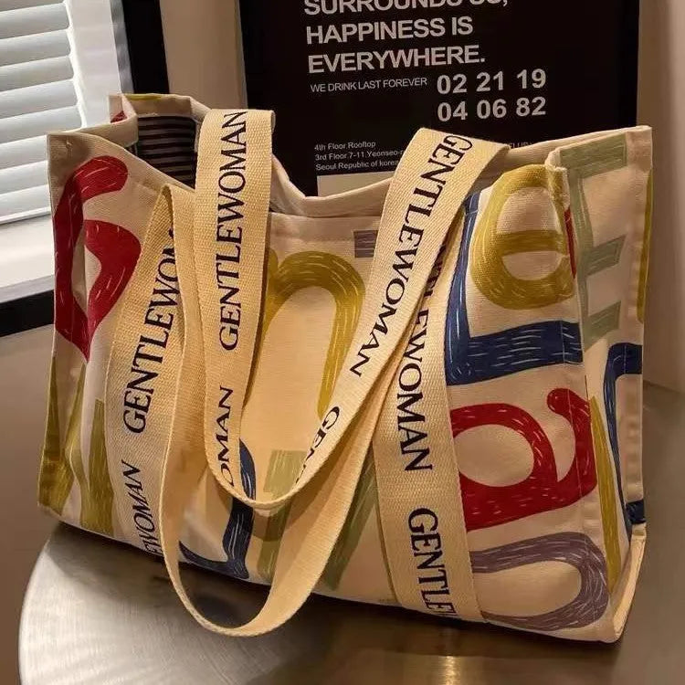 Large canvas tote bag with printed design, shown in multiple colour and pattern options.