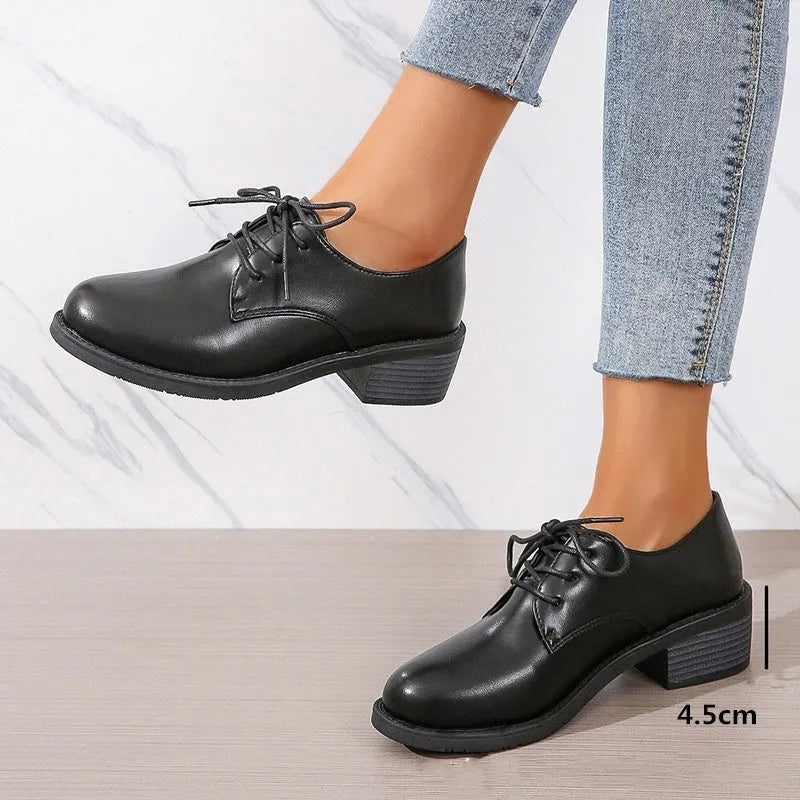 Black women's low-top slip-on work shoes with a chunky mid-heel and rounded toe.