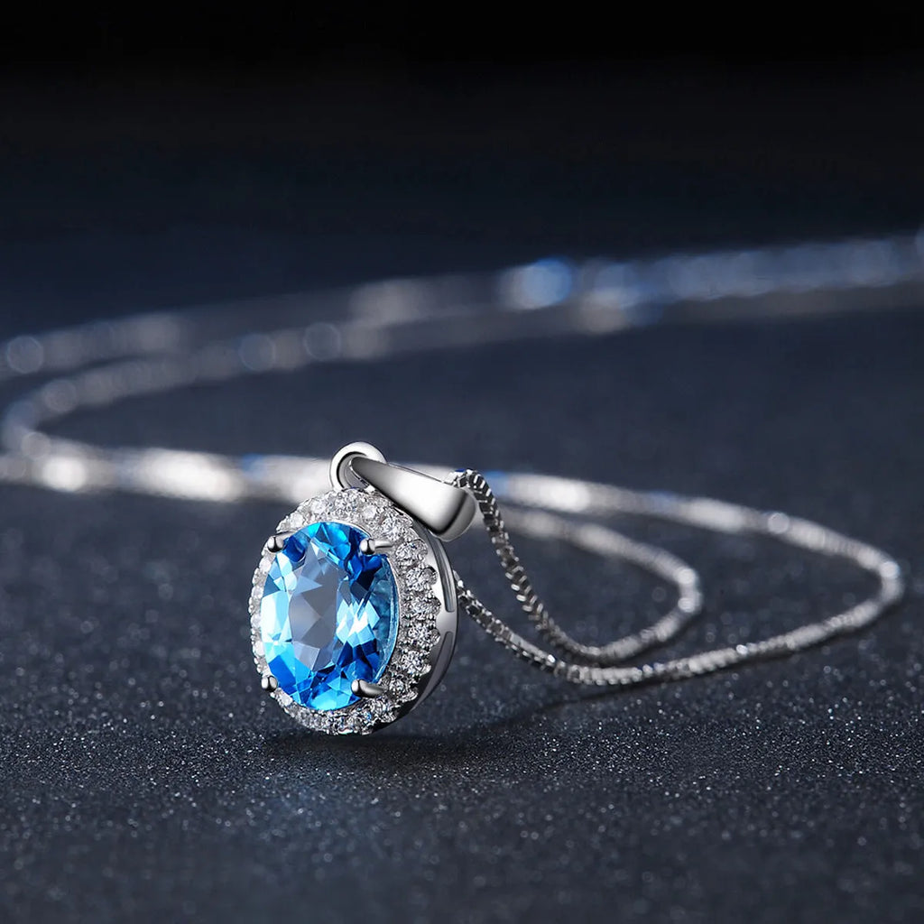 925 sterling silver jewellery set with blue topaz stones including geometric earrings, necklace, ring and pendant
