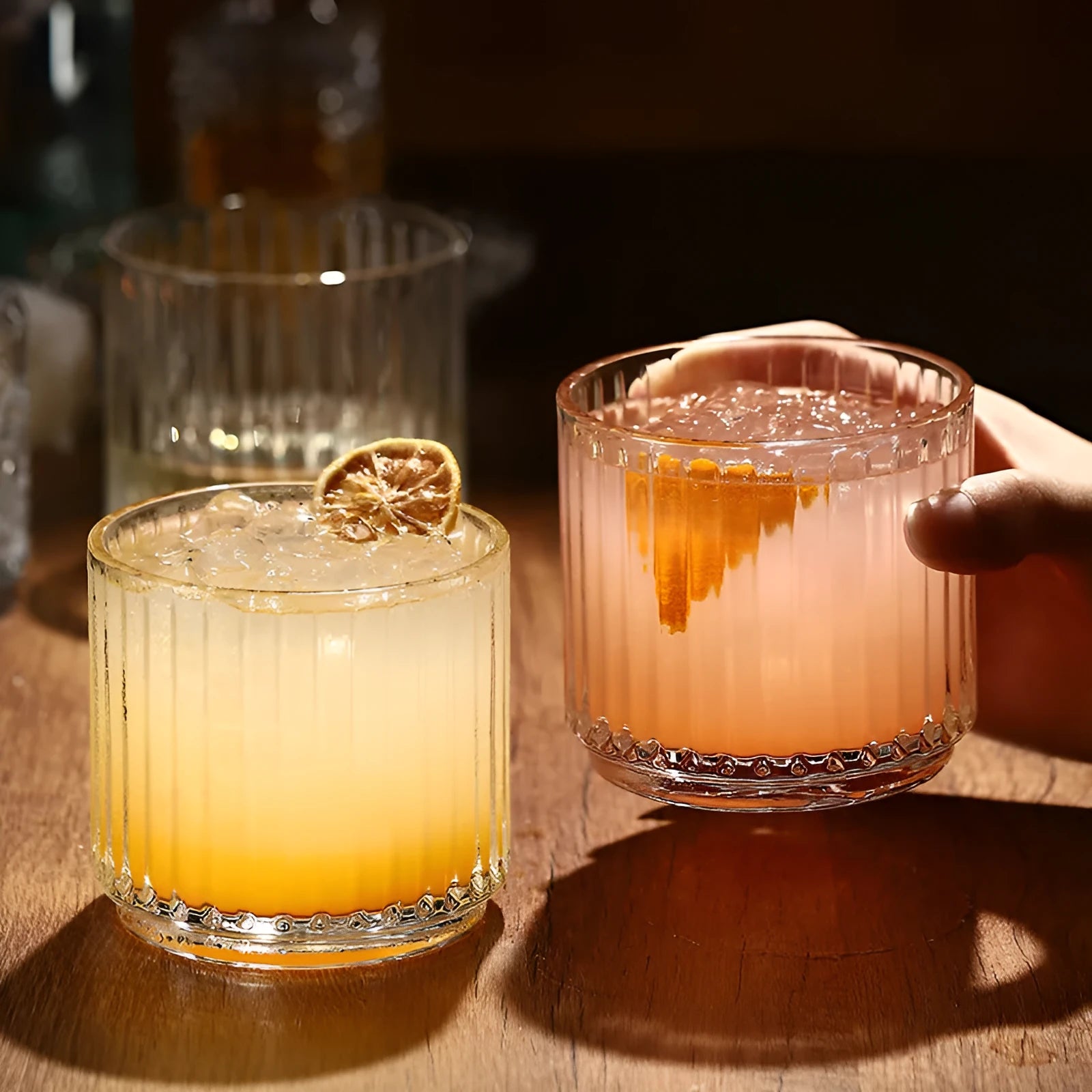 Stackable engraved glass wine glasses and sake barrel on a table