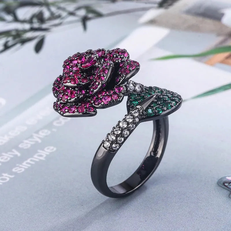 Gold-plated geometric flower ring with red simulated corundum stone on black gold band