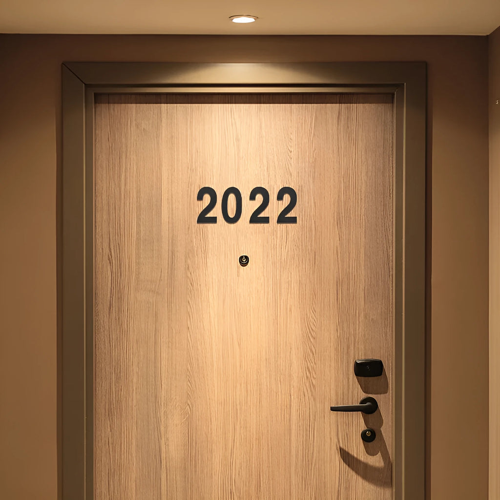 Black stainless steel house number with adhesive backing showing 7.5cm character size