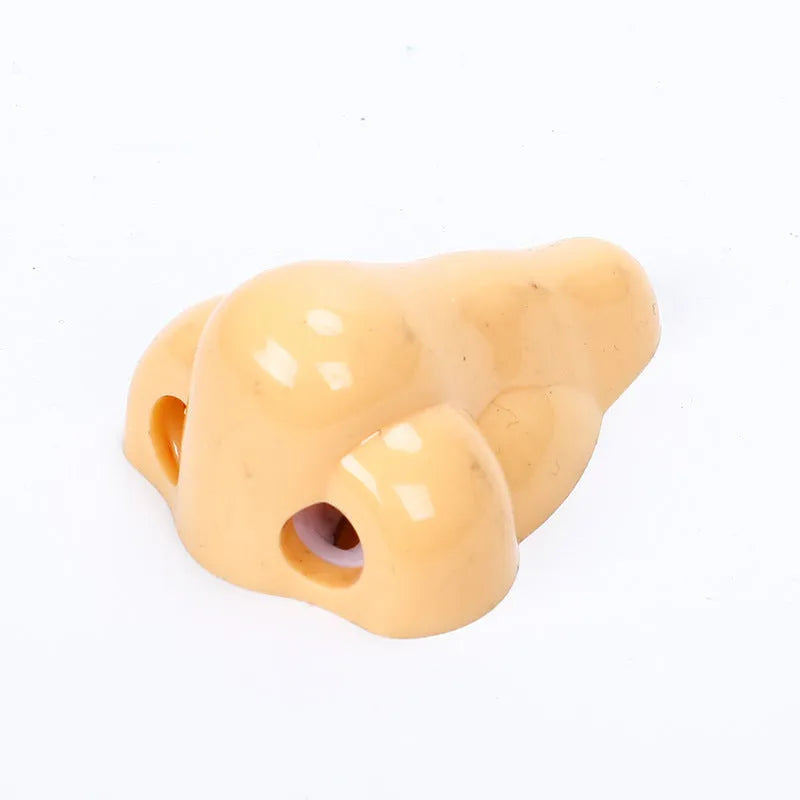 Flesh colour plastic manual pencil sharpener with large shaving container measuring 58x45x30mm