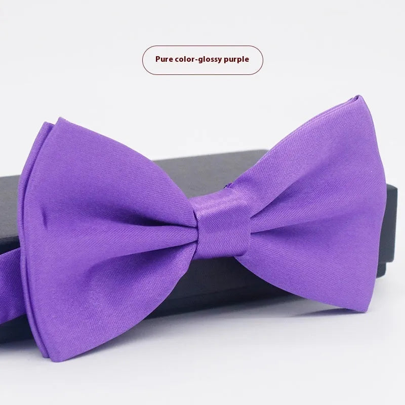 Men's flat head style polyester bow tie in a solid colour, shown with adjustable neck strap.