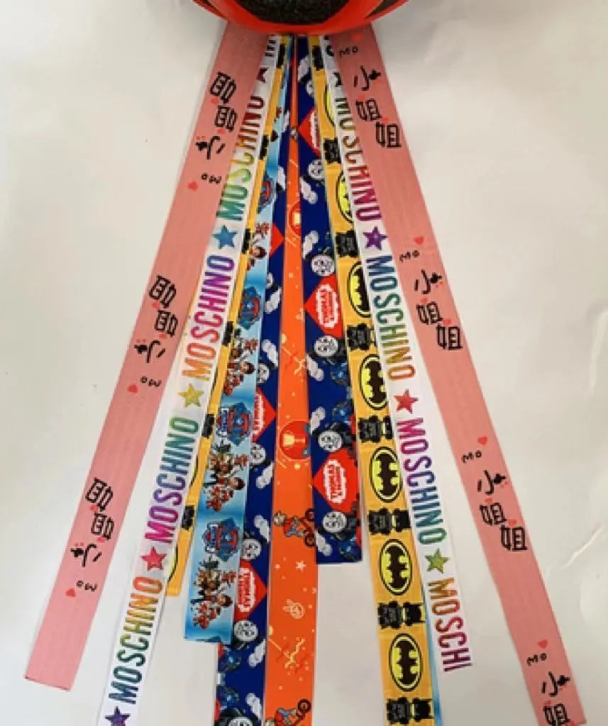 Colourful decorative ribbon streamers attached to a children safety helmet for skating or skiing