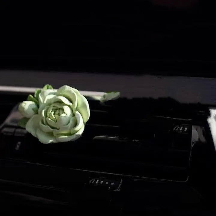 Solid jasmine car perfume for air vent with gypsum base and essential oil bottle in beige white or green.