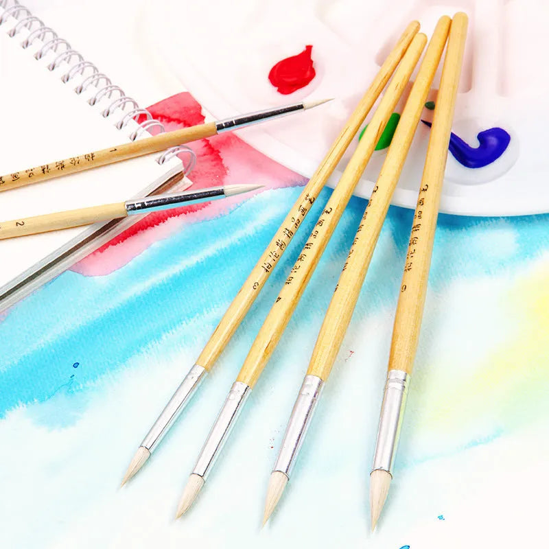 Six wooden-handled artist brushes with pointed wool tips arranged together.