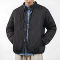 Men's black diamond quilted winter jacket with a loose, longline fit and zip-up front.