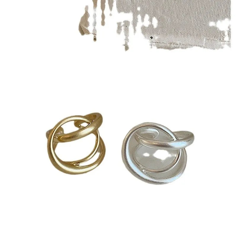 Geometric open ring with three-dimensional interlaced design in matte metal finish
