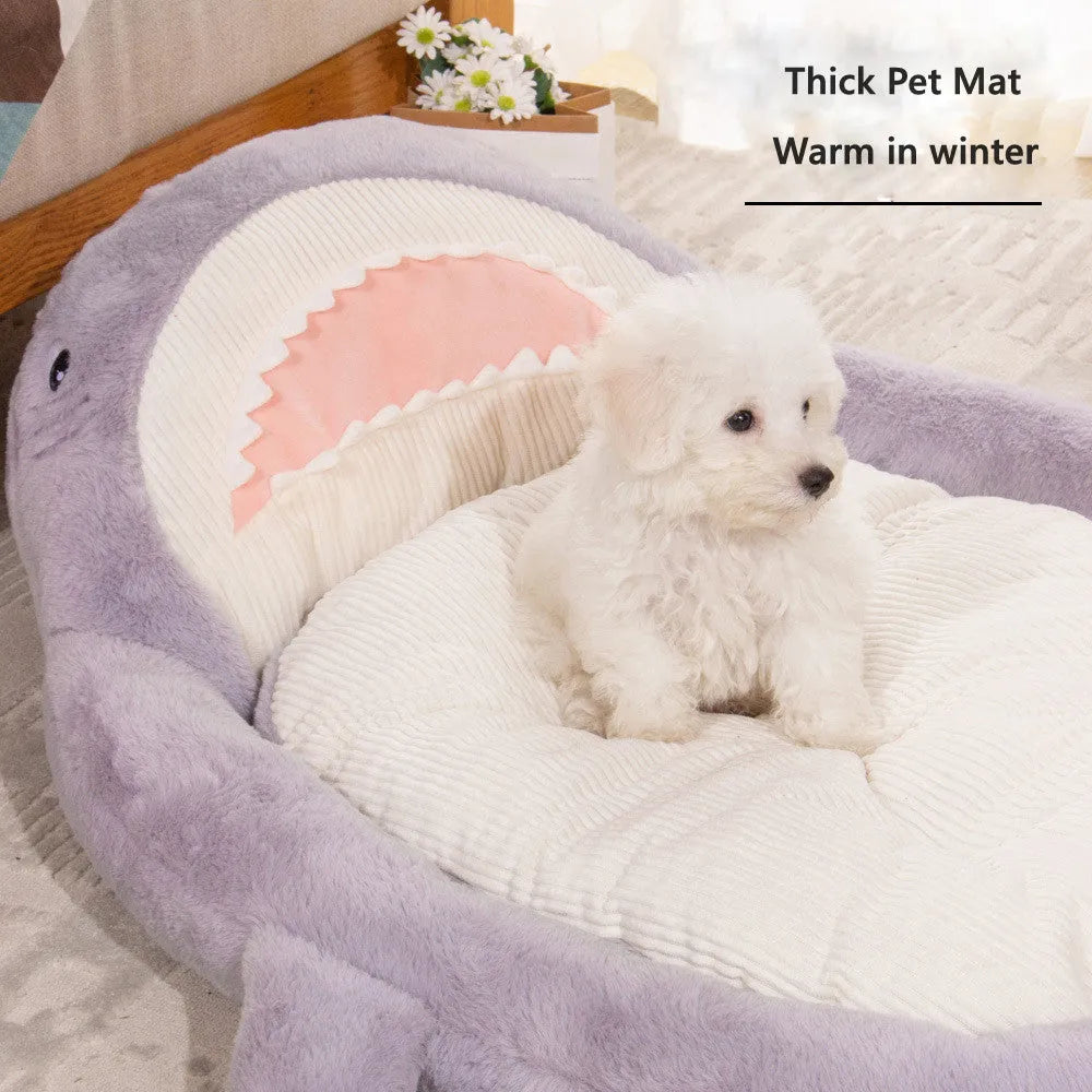 Blue shark pattern pet bed cushion on a floor, showing soft velvet material and non-slip base.