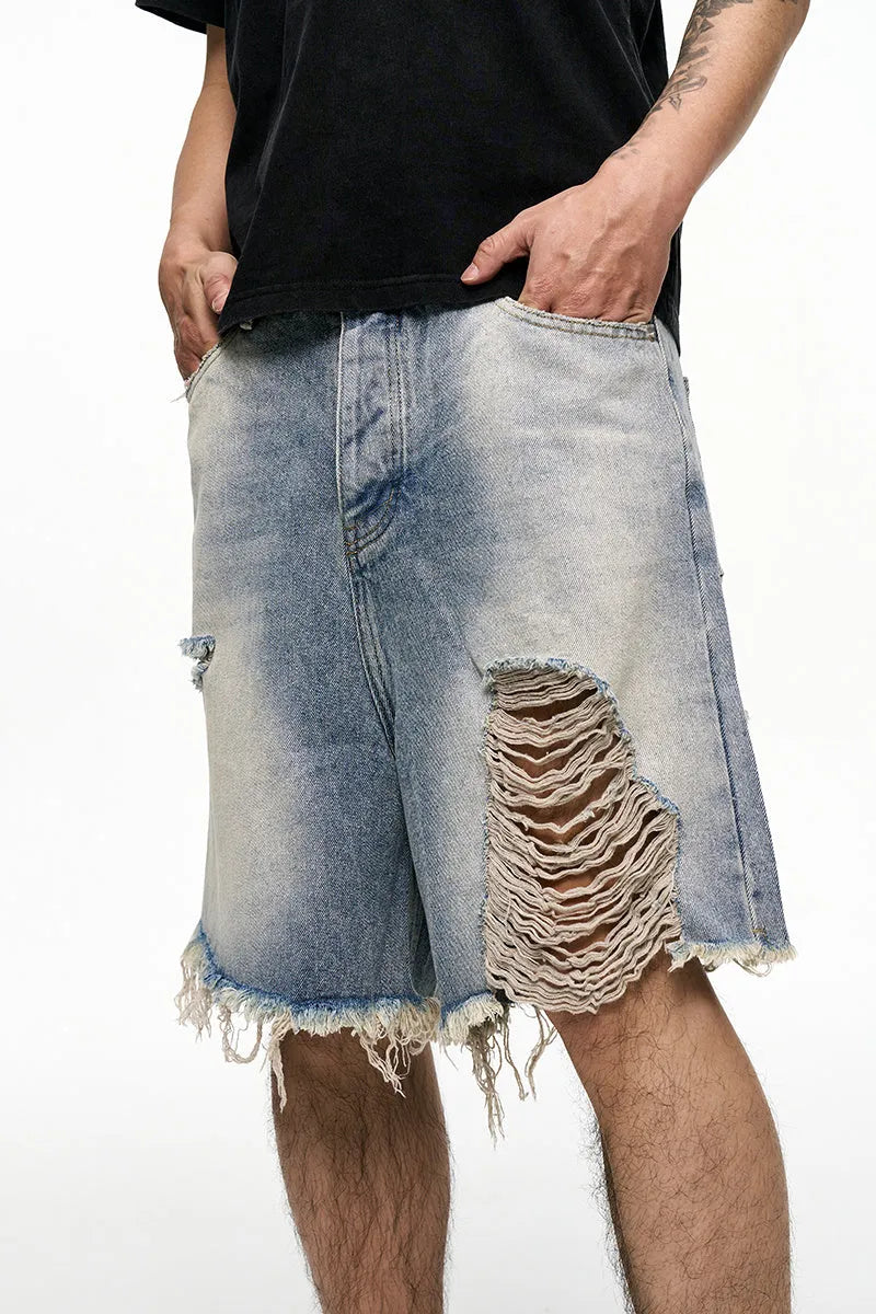 Light blue washed men's denim shorts with a baggy wide leg fit on a mid waist.