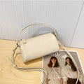 Soft genuine leather cylindrical crossbody phone bag in brown with a single shoulder strap.