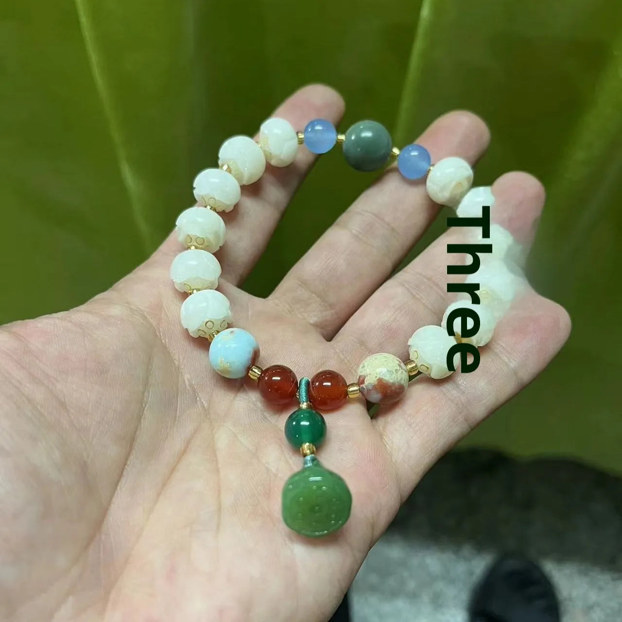 Carved pumpkin and lotus bead bracelet made from Bodhi root with white jade and aventurine details.