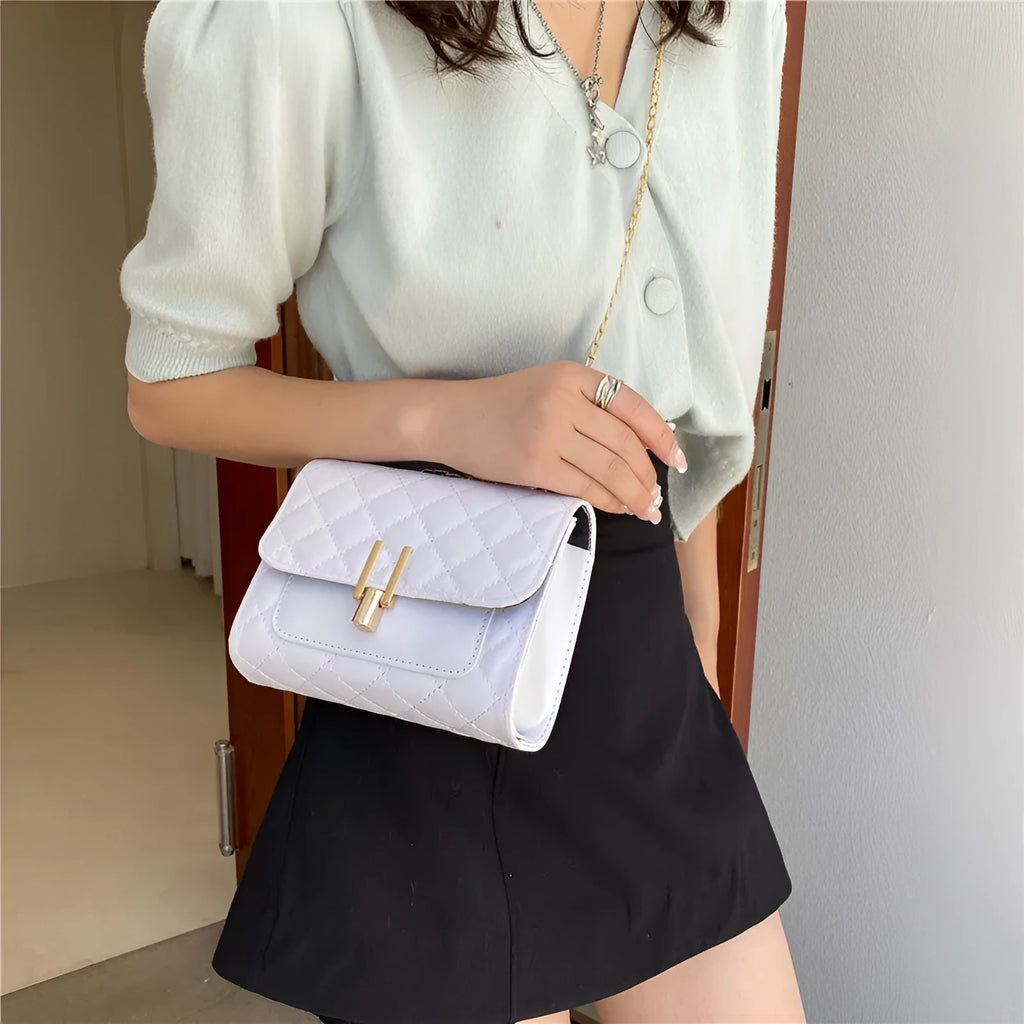 Women's diamond lattice chain crossbody bag in black with adjustable shoulder strap