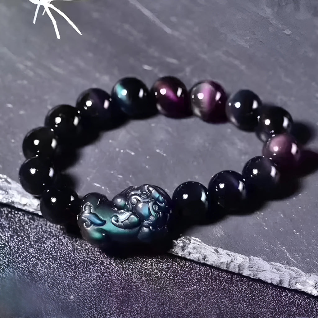 Natural ice colour Eye Obsidian crystal beaded bracelet on a wrist, showing round beads.
