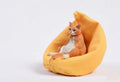 Small lazy cat car ornament and sofa, 7.5cm tall resin model on a car dashboard.