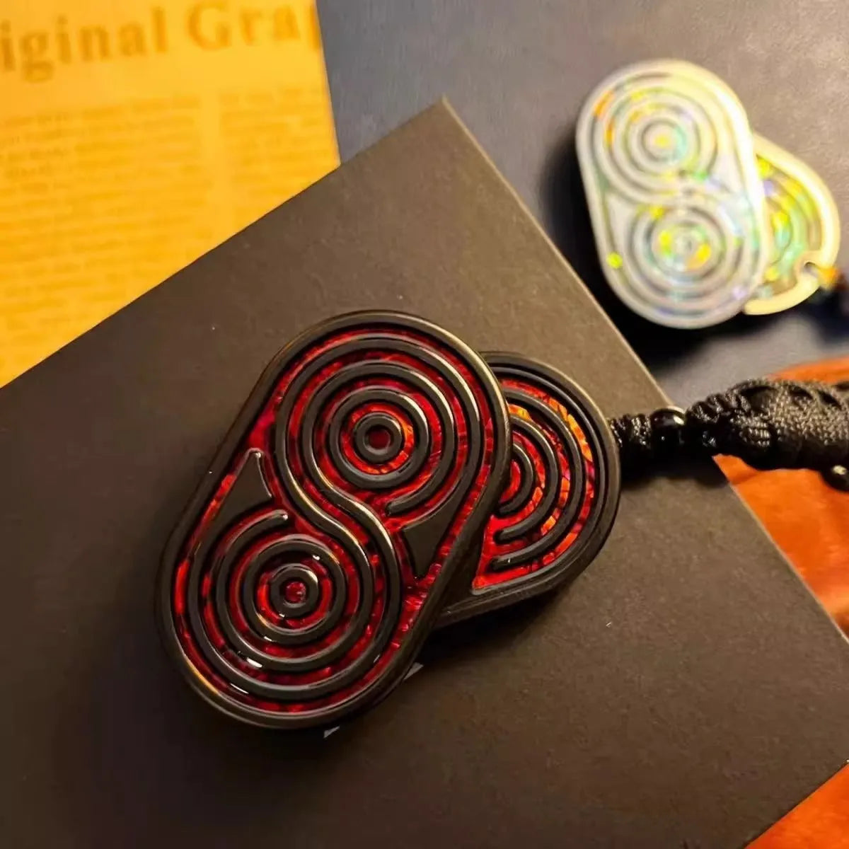 Stainless steel EDC hand push coin in agate red colour on plain background