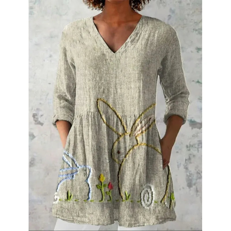 Women's long loose dress with a blue and white wave print pattern, featuring three-quarter sleeves and a wide waist.