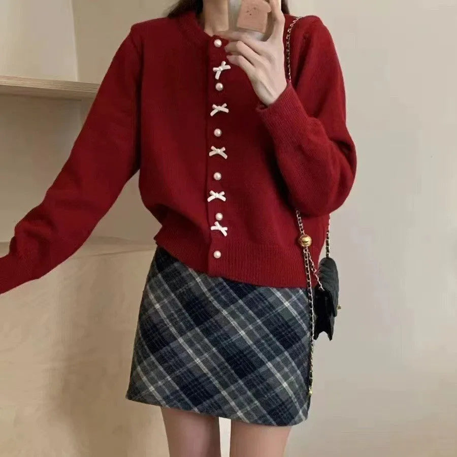 Women's solid colour cardigan sweater with bow and pearl button design in medium thickness fabric