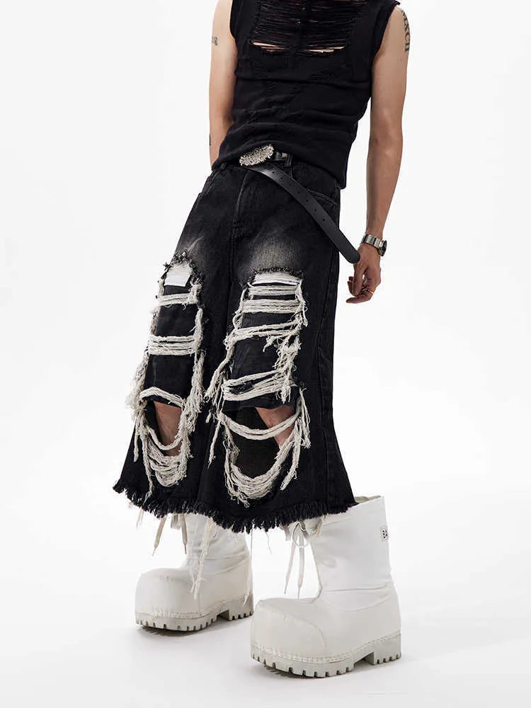 Black women's wide-leg cropped jeans with ripped patch details on the legs.