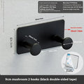 Iron adhesive wall hook with multiple arms on shower door, white double-sided tape visible